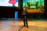 Dekan Prof. Dr. Michael Kellmann hält die Grußworte bei RUB Finish 2026 auf der Bühne des Audimax der RUB